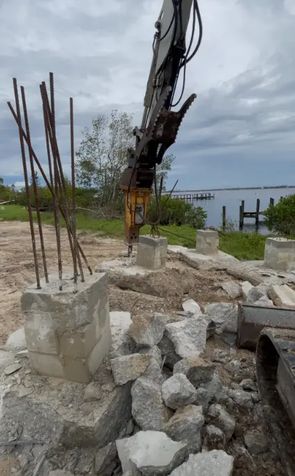 Demolition crew demolishing damaged building in Pine Island