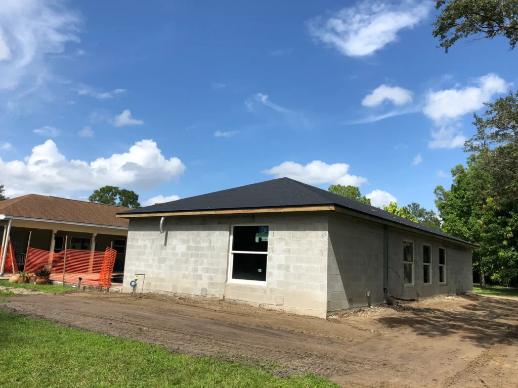 Construction contractor preparing for landscaping of dried-in home