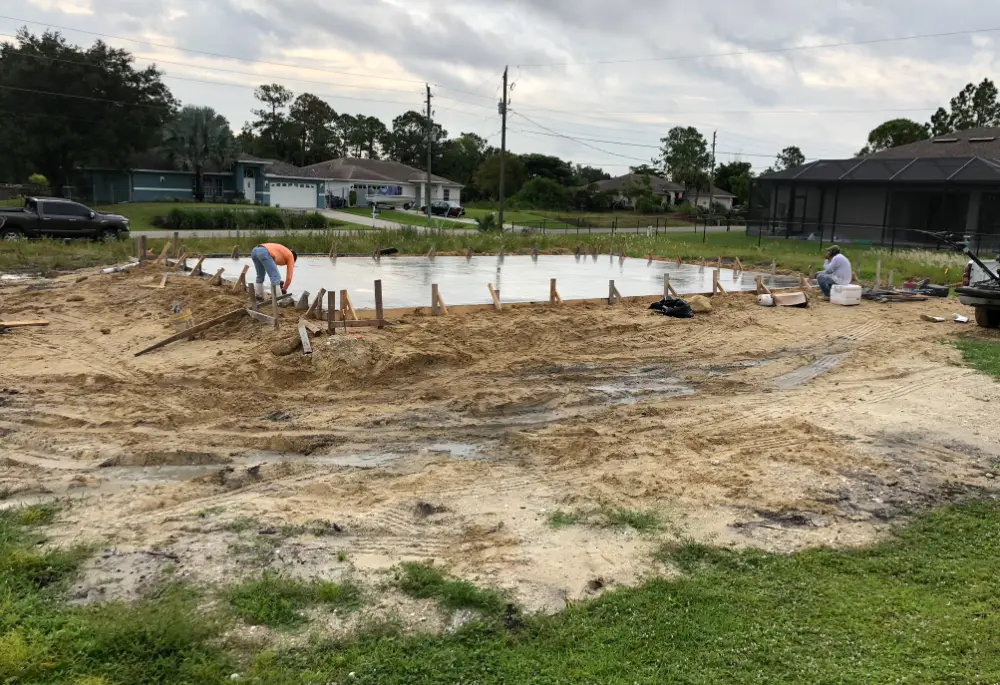 construction contractor finishing concrete slab in Bonita Springs home