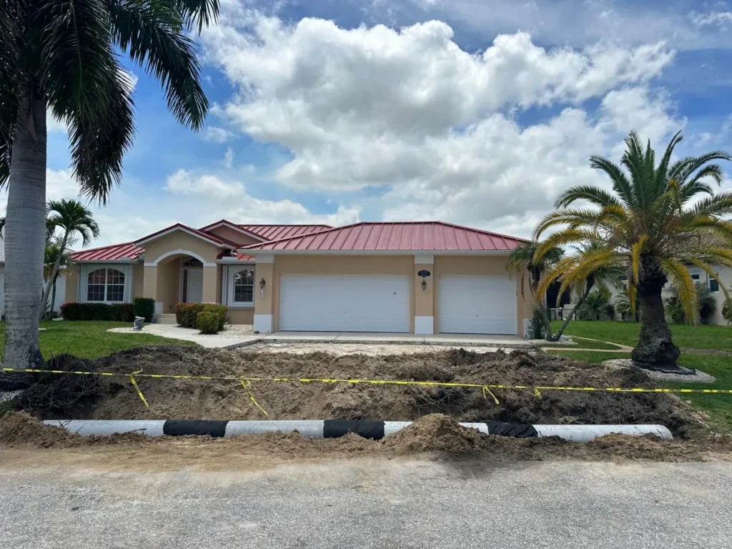 Installation of culverts in front of a house.