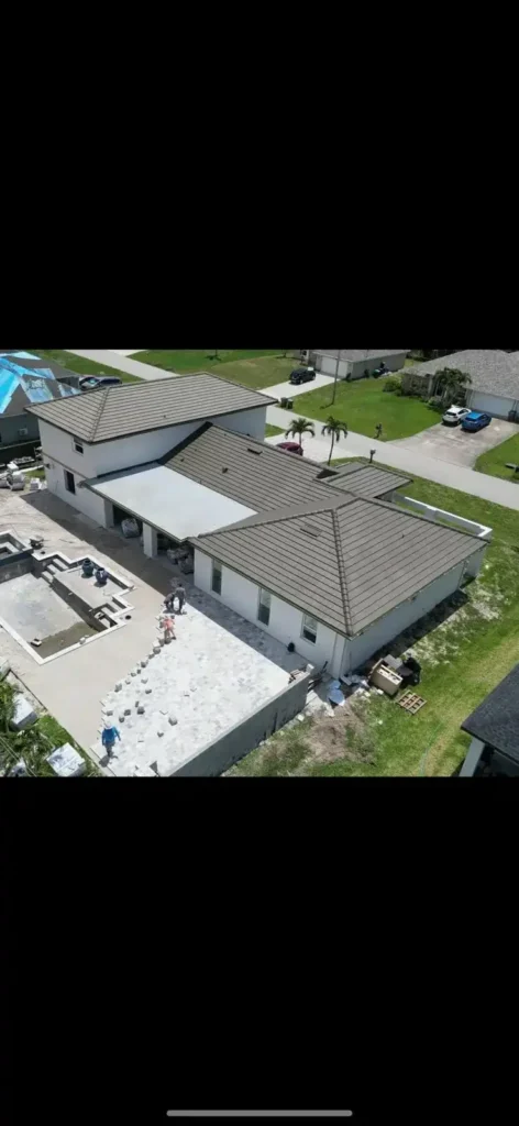 Large pool construction with pavers being installed.