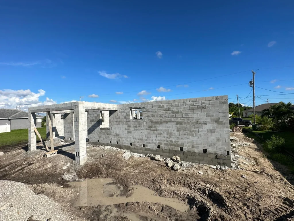 Masonry walls seen from the road during construction.