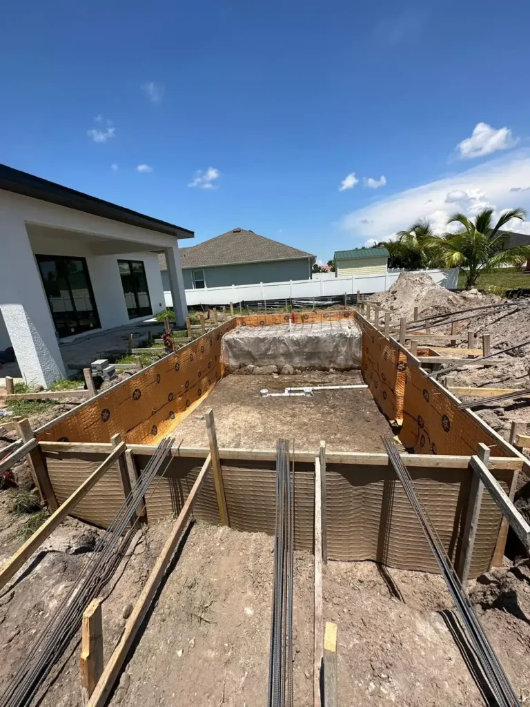 Pool and spa under construction with extensive formwork.