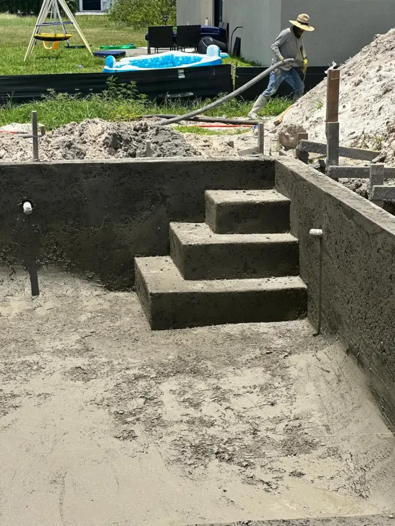 Pool under construction with concrete stairs or steps