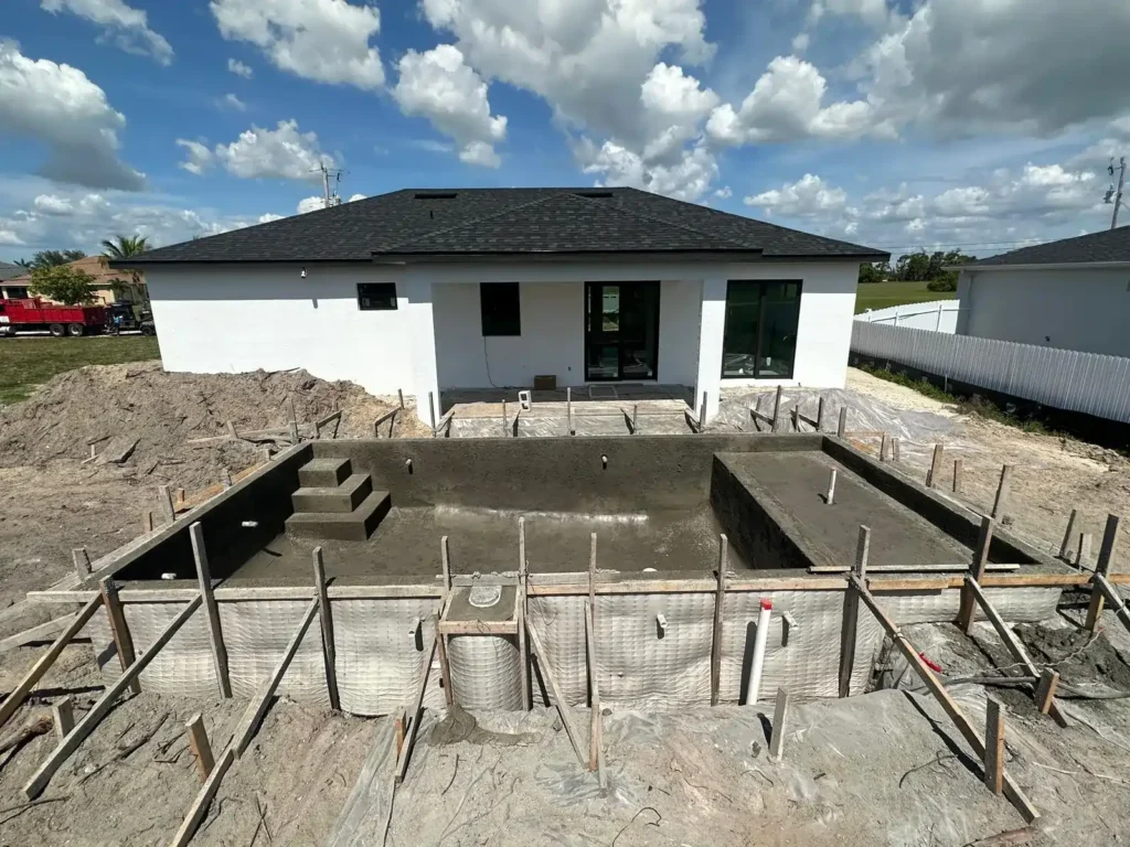 Pool construction in a Cape Coral home backyard.