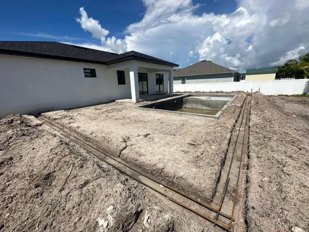 Rebar laid for pool footing at a corner angle.