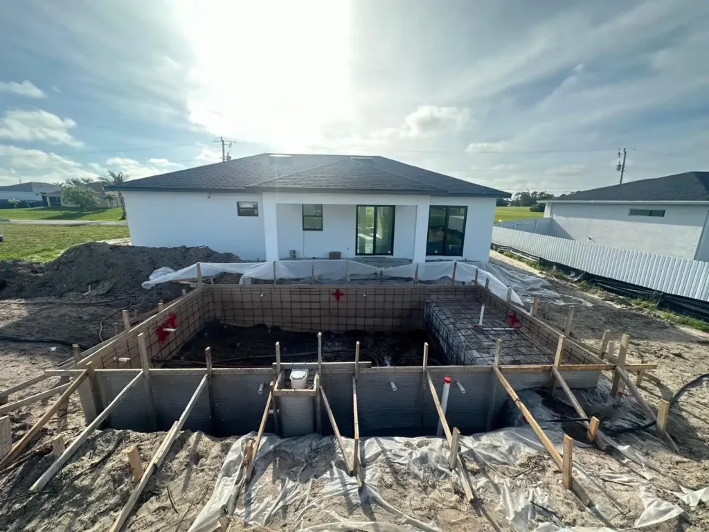 Pool under construction with wooden formwork and mesh.