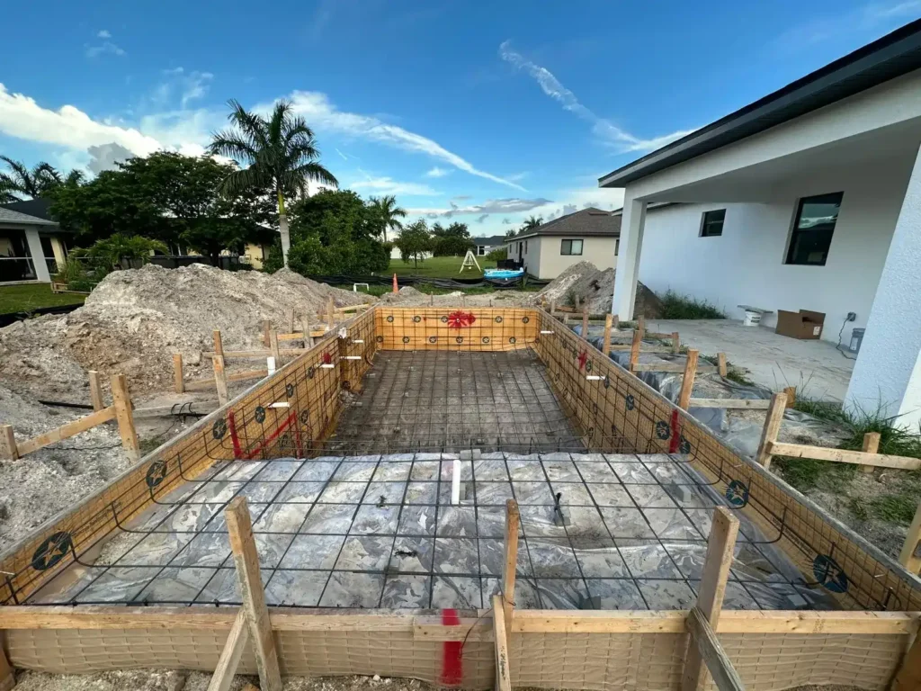 Close-up of pool construction with mesh and formwork.