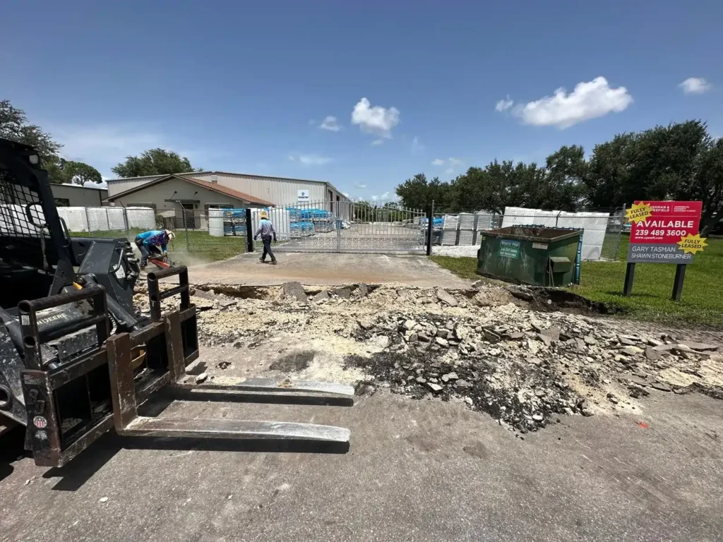 Close-up of concrete slab removal at a construction site.