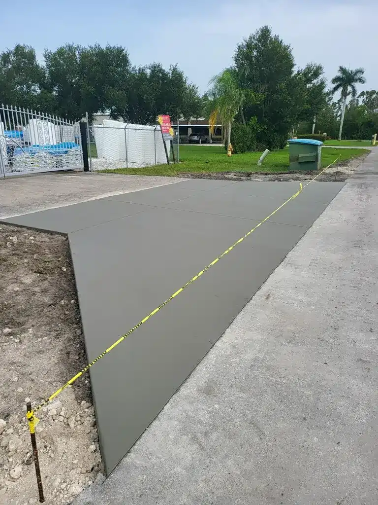 Fresh concrete drying with caution tape around it