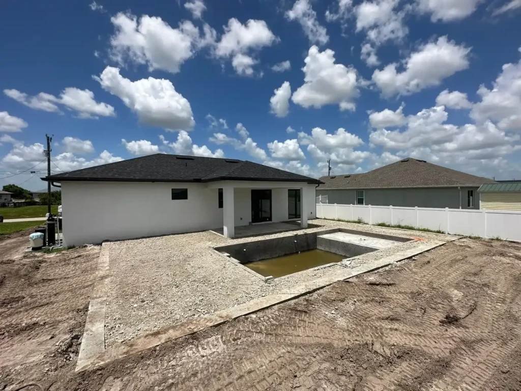 Backyard with prepared pool deck area ready for pavers.