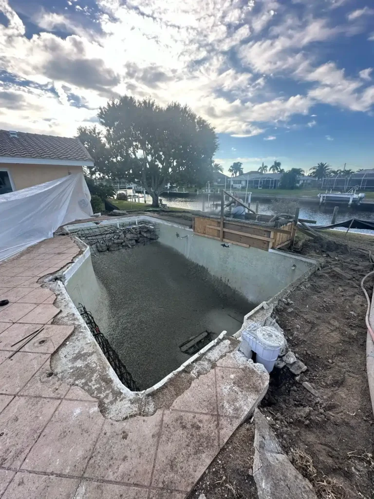 Early stage of pool renovation with excavation and structural changes.