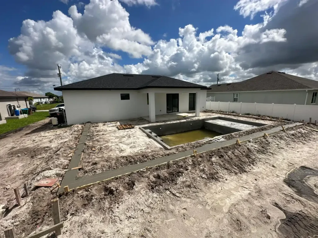 Overview of pool renovation with concrete foundation and surrounding construction.