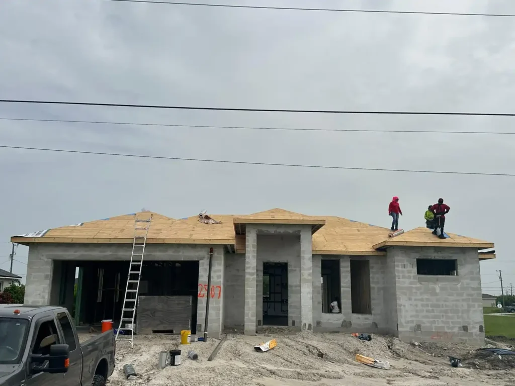 Workers beginning the roof dry-in process.