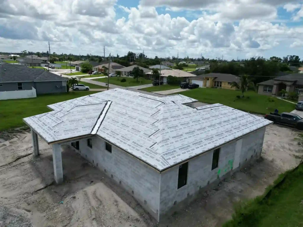 Roof underlayment installation from a top-angle view on a new home.