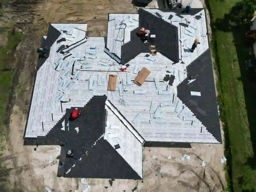 Aerial view of a roof under active installation.