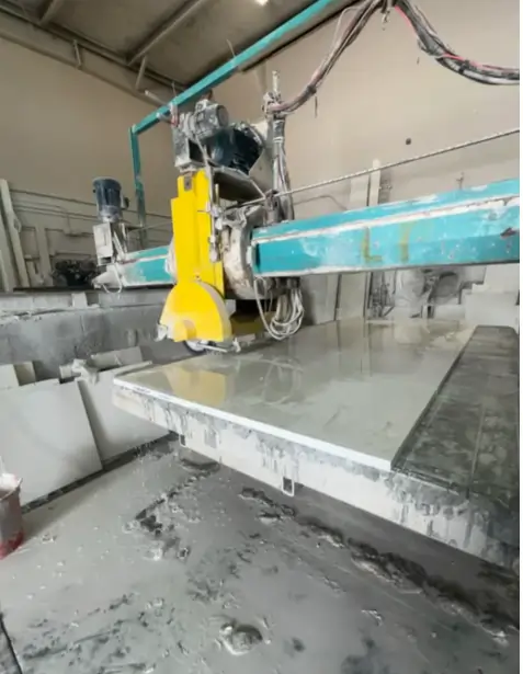 A large cutting machine fabricating a countertop slab in Tarpon Gulf’s in-house facility.