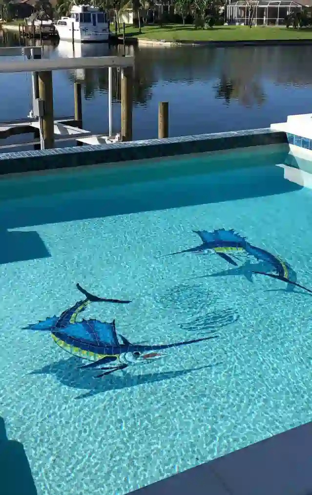 Mosaic of two fish with shadows at the bottom of a pool.