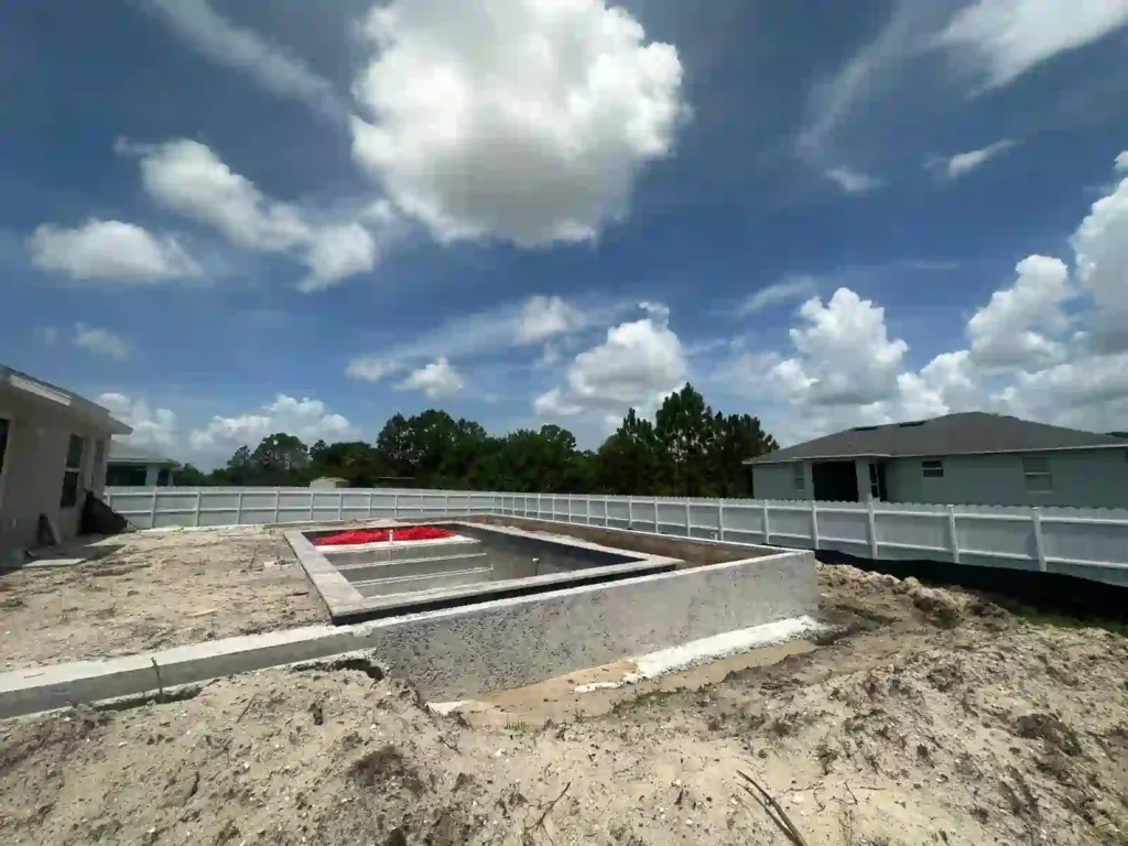 Elevated swimming pool with deck under construction.