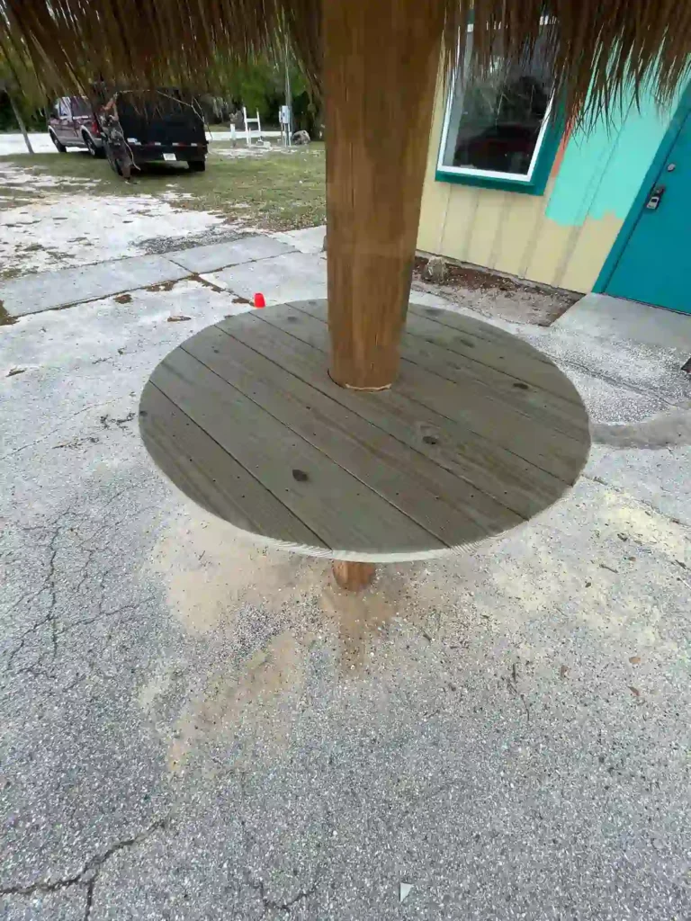 Tiki hut with a small integrated table around a support column.