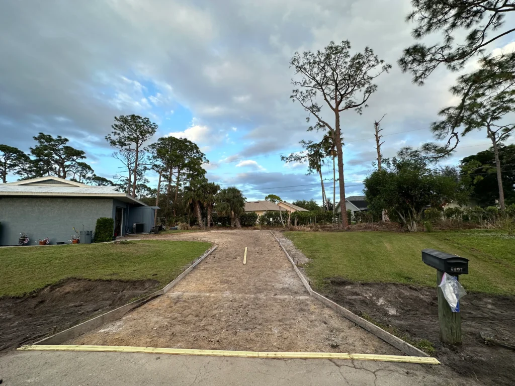 Residential concrete driveway with forms installed, ready for concrete pouring.