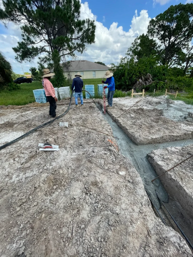 Concrete crew actively pouring a footer for a strong and stable foundation.